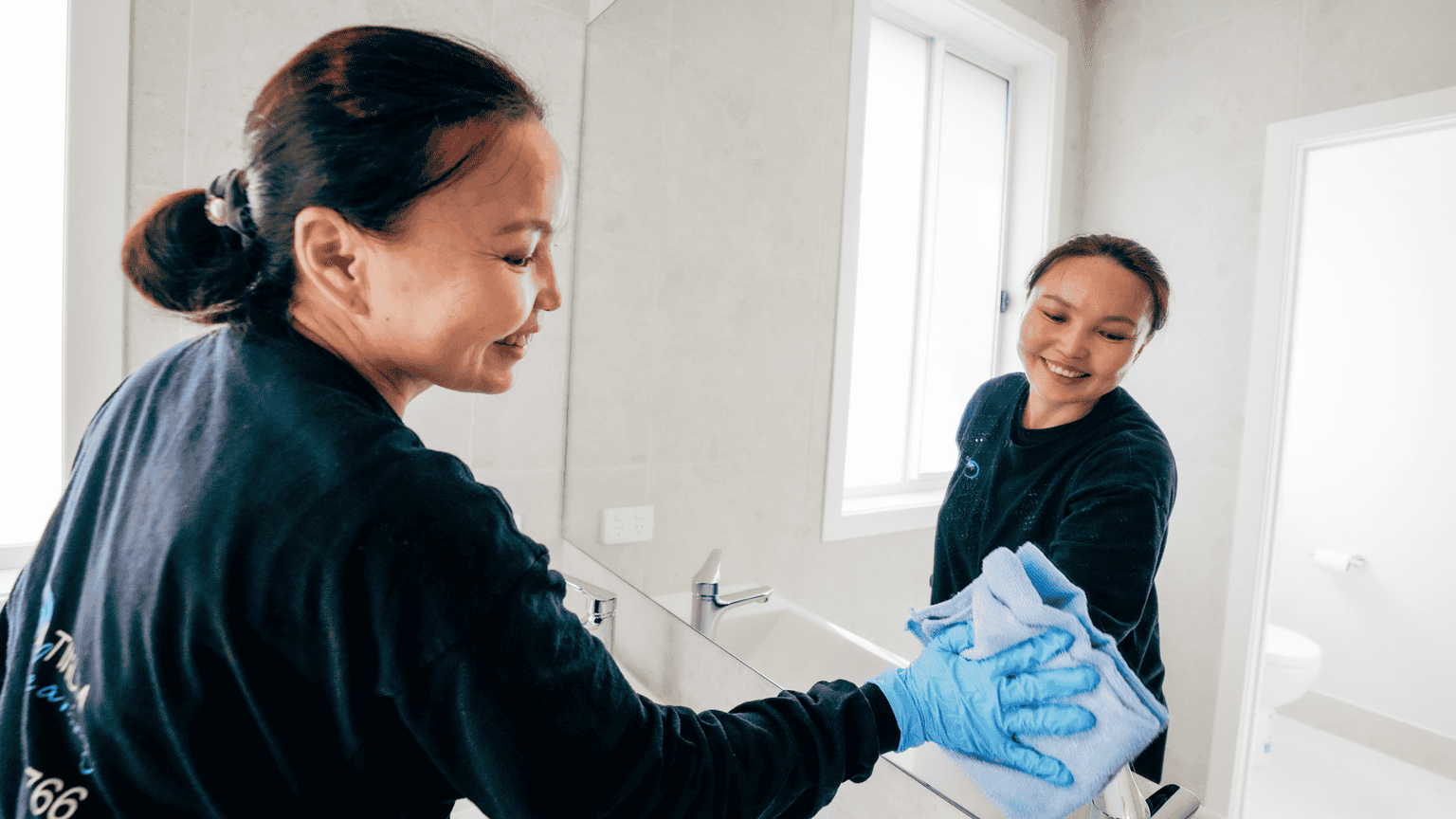 Platinum Cleaning Group Wiping Mirror Bathroom smilingpcg